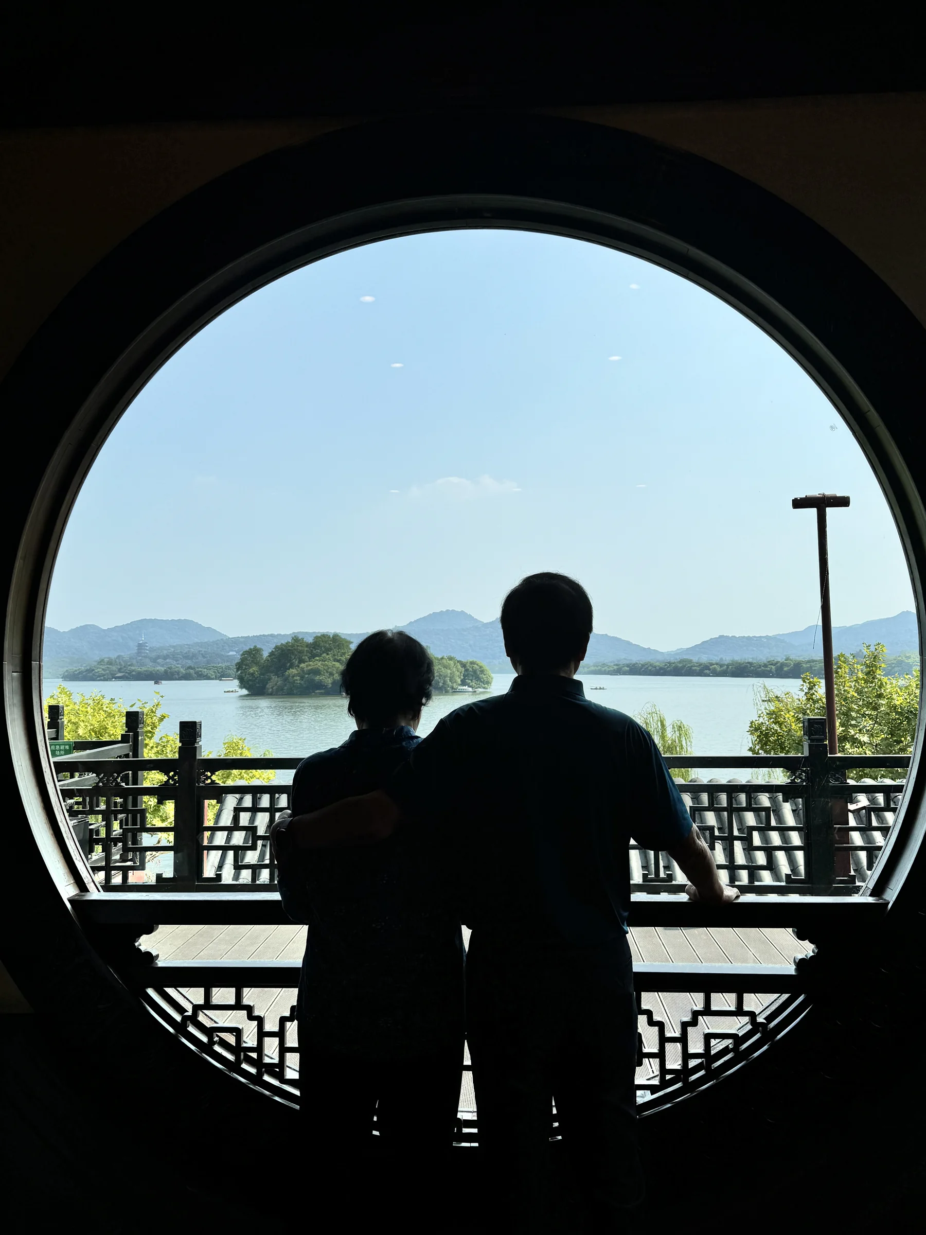 Silhouette of my maternal grandparents framed by a circular window